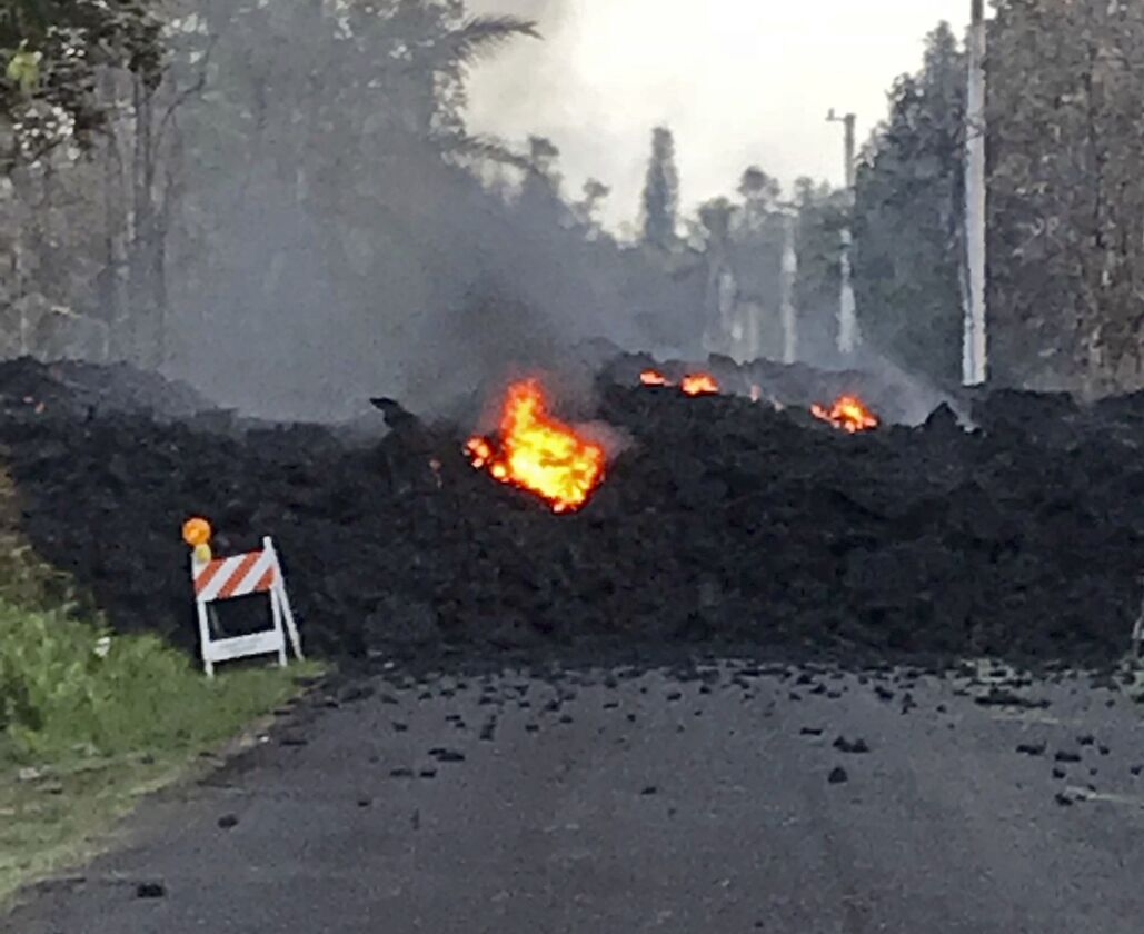 This photo provided by Hawaii Electric Light shows lava flowing over Mohala Street in the Leilani Estates area near Pahoa on the Big Island of Hawaii Friday, May 4, 2018. Nearly 1,500 people have fled from their homes after Hawaii’s Kilauea volcano sent m